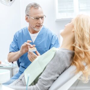 Dentist giving advice for bad dental implants